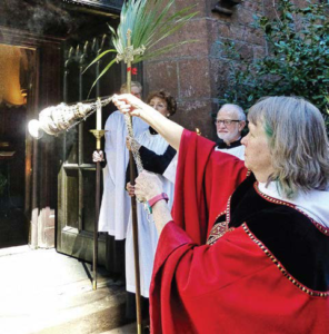 Mother Liz censing the church door on Palm Sunday